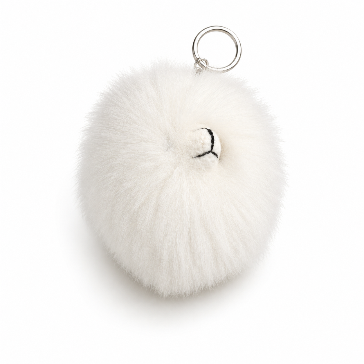 White fluffy pom-pom keychain on a white background